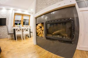 a large fireplace in a living room with a table at "Między Gruszką a Sanem" in Lesko