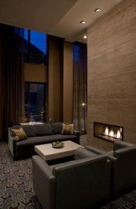 a living room with two couches and a fireplace at L'Hermitage Hotel in Vancouver