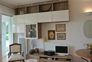 a living room with white cabinets and a table at Les Bastides 3028 in Grimaud