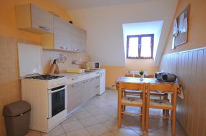 a kitchen with a table and a stove top oven at Pension Chalupka l with a panoramic view of Spiš Castle in Spišské Podhradie +24 photos