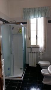 a bathroom with a shower and a toilet and a sink at Garden Fiorella in Cinisi