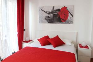 a bedroom with a red bed with a red backpack on it at Apartment De Rossi in Bari