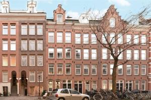 a car parked in front of a large brick building at Da Costastraat in Amsterdam