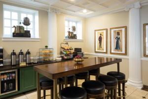 a dining room with a table and stools at The Willows Hotel in Chicago