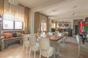 a dining room with a wooden table and white chairs at Glamping & Camping Green Istria in Marezige +88 photos