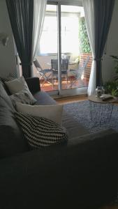 a living room with a couch and a view of a patio at Liberdadeflat4u in Braga