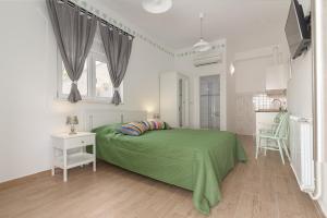 a bedroom with a green bed and a table at Guesthouse Green Istria in Truške
