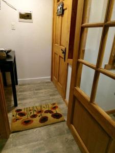 a door leading into a room with a welcome mat at El Pionero in Coihaique