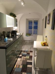 a kitchen with a counter and a table with chairs at New flat in old town+garage in Steyr