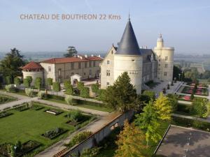 a large castle with a garden in front of it at Le Perron in Lézigneux +11 photos