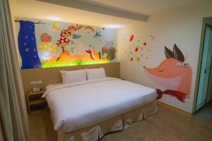 Postel nebo postele na pokoji v ubytování Legend Hotel Kaohsiung Liuhe