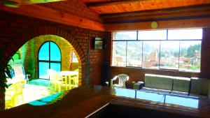 a kitchen with a large window with a view of a patio at La Casa de Maruja B&B in Huaraz
