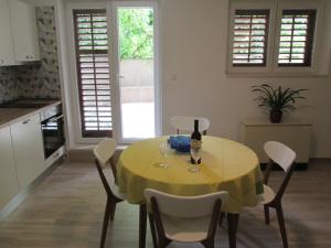 a kitchen with a table with a bottle of wine at Velin Apartment in Split