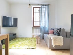 a living room with a couch and a tv at Przy Rynku in Gliwice