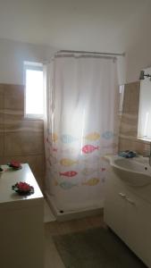 a bathroom with a shower curtain and a sink at Casa Barroca in Carrapateira +38 photos