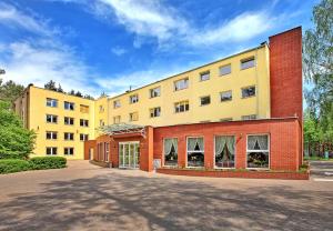 a large building with a red brick at Best Inn in Bydgoszcz