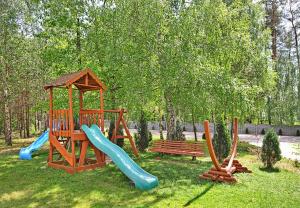 a playground with a slide and a bench in a park at Best Inn in Bydgoszcz