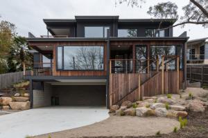 a modern house with a large glass facade at Brooklands Apartments in Healesville