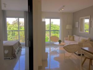 a living room with a couch and a table at 9 de Julio Park Suites in San Miguel de Tucumán