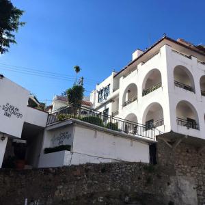 a white building with balconies on the side of it at Hotel Real de San Diego in Taxco de Alarcón