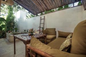 an outdoor patio with a table and chairs at Karmagali Suites Adults only & Private Pool Family Villas in Sanur