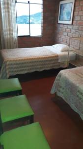 En eller flere senge i et værelse på Casa de playa tortugas