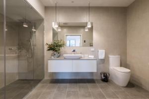 a bathroom with a sink and a toilet and a shower at Brooklands Apartments in Healesville +18 photos