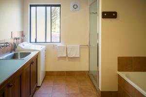 a bathroom with a sink and a shower at Wyadup Brook Cottages in Yallingup +28 photos