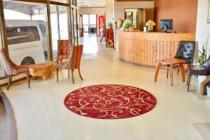 a lobby with chairs and a rug on the floor at Altitude Nozawa in Nozawa Onsen