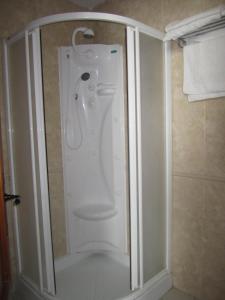 a shower stall in a bathroom with a toilet at Hostal La Conileña in Conil de la Frontera