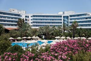 a resort with a swimming pool and a large building at Sunrise Resort Hotel in Kizilagac