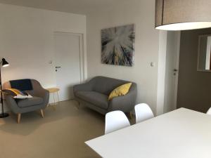 a living room with a couch and a chair at Apartments Renata in Pinezici