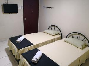 Postel nebo postele na pokoji v ubytování Kristal Inn Hotel UITM Shah Alam