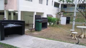 a group of trash cans sitting outside of a building at Rose Condo@ Cocobay Beach Resort in Port Dickson