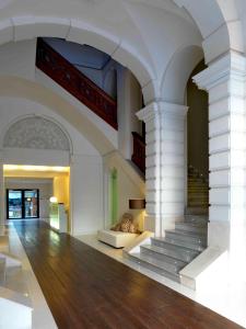 a lobby with a staircase in a building at Hospes Palau de La Mar in Valencia