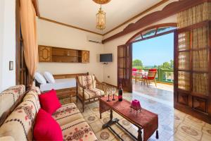 a living room with a couch and a table at Villa Agia Galini in Archangelos