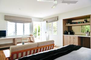 a living room with a bed and a couch at Orpheus Island Lodge in Orpheus Island