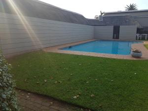 a swimming pool in the backyard of a house at Riversway Guest House in East London