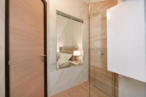 a bathroom with a shower and a mirror at Harvey's luxury rooms in Zadar