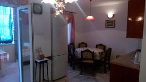 a kitchen and dining room with a table and chairs at Lubin in Sevid