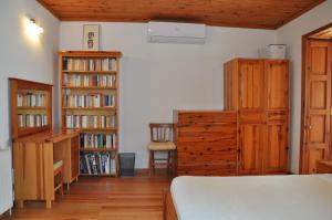 a bedroom with wooden furniture and book shelves at Garden House in Selçuk
