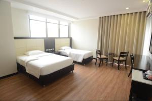 Postel nebo postele na pokoji v ubytování Ever O Business Hotel