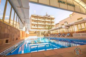 a large swimming pool in a building with a hotel at Hotel Victoria in Segur de Calafell