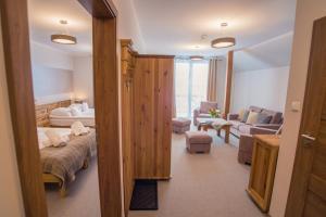 a room with a living room with a couch and a living room at Orlicka Skała in Zieleniec +80 photos