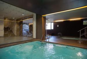 a large swimming pool in a room with at Hotel Laterum in Pécs