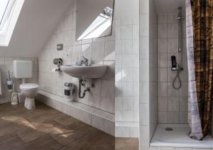a bathroom with a sink and a toilet at BoardingHouse Quickborn in Quickborn +17 photos