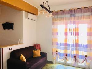 a living room with a couch and a window at Casa Terme in Sciacca