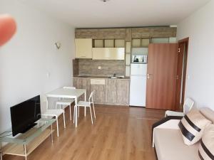 a kitchen and a living room with a table and chairs at Villa Ilchev in Sozopol