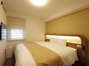 Postel nebo postele na pokoji v ubytování Hotel Sunroute Sopra Kobe Annesso