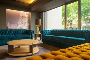 a living room with two blue couches and a coffee table at HF Tuela Porto in Porto